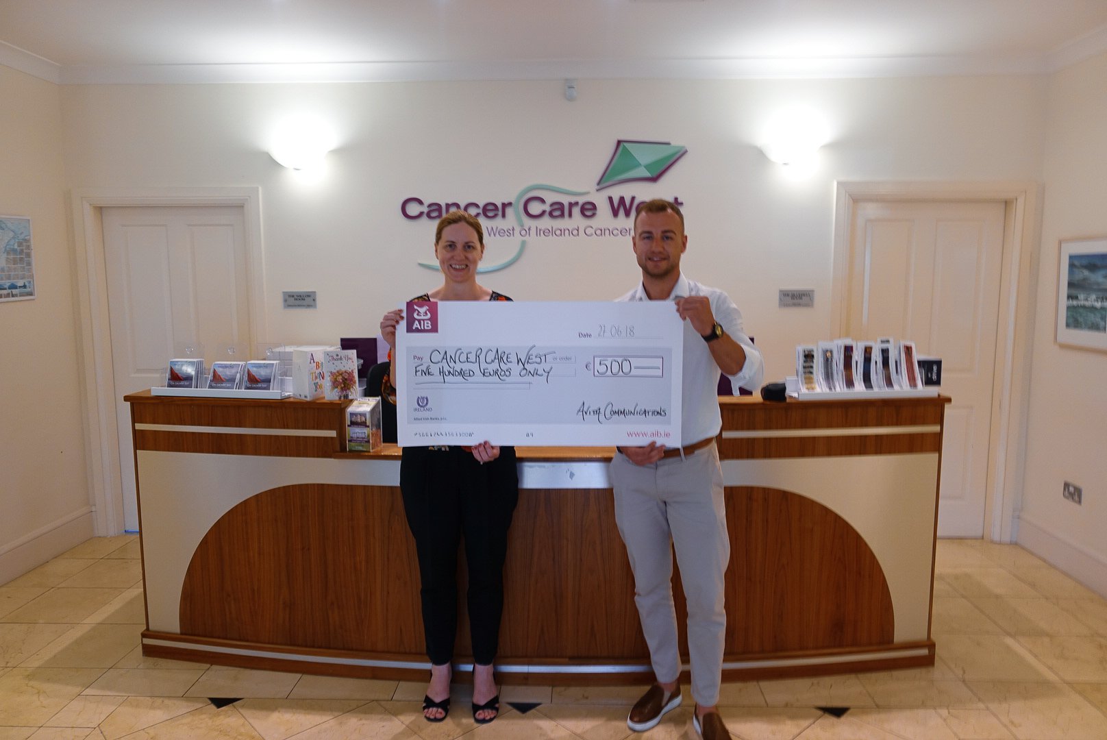 Evin presenting donation check to Cancer Care West 